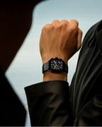 Side view of the Black Zypher watch by Clasicio, showcasing the polished black alloy case and textured industrial chronograph pushers.
